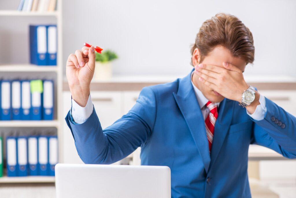 Businessman throwing dart in business concept Risk Informed Decision-Making Guide