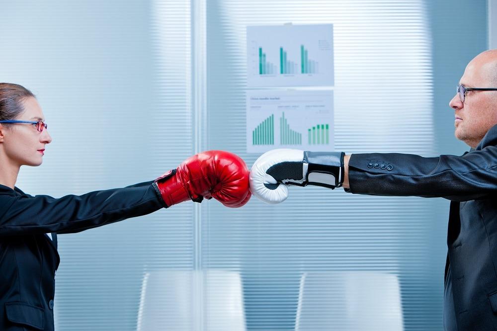 two businesspeople boxing near window two businesspeople boxing near window