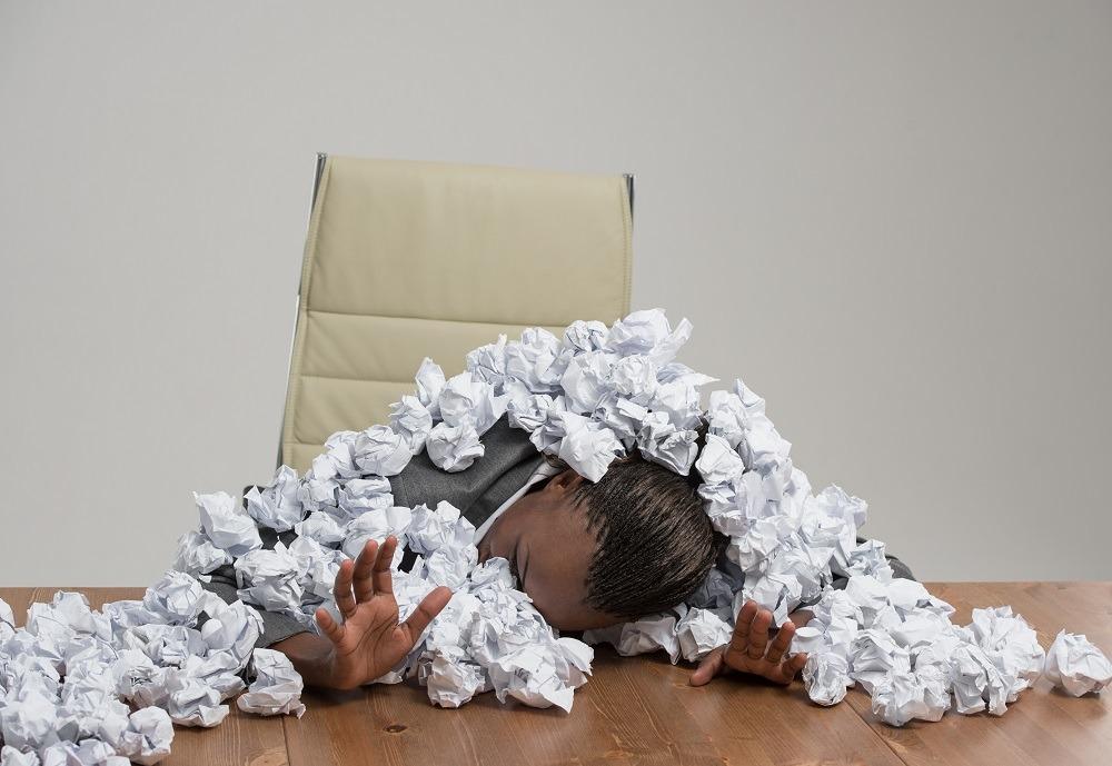 Business woman covered in crumpled papers phoenix it services